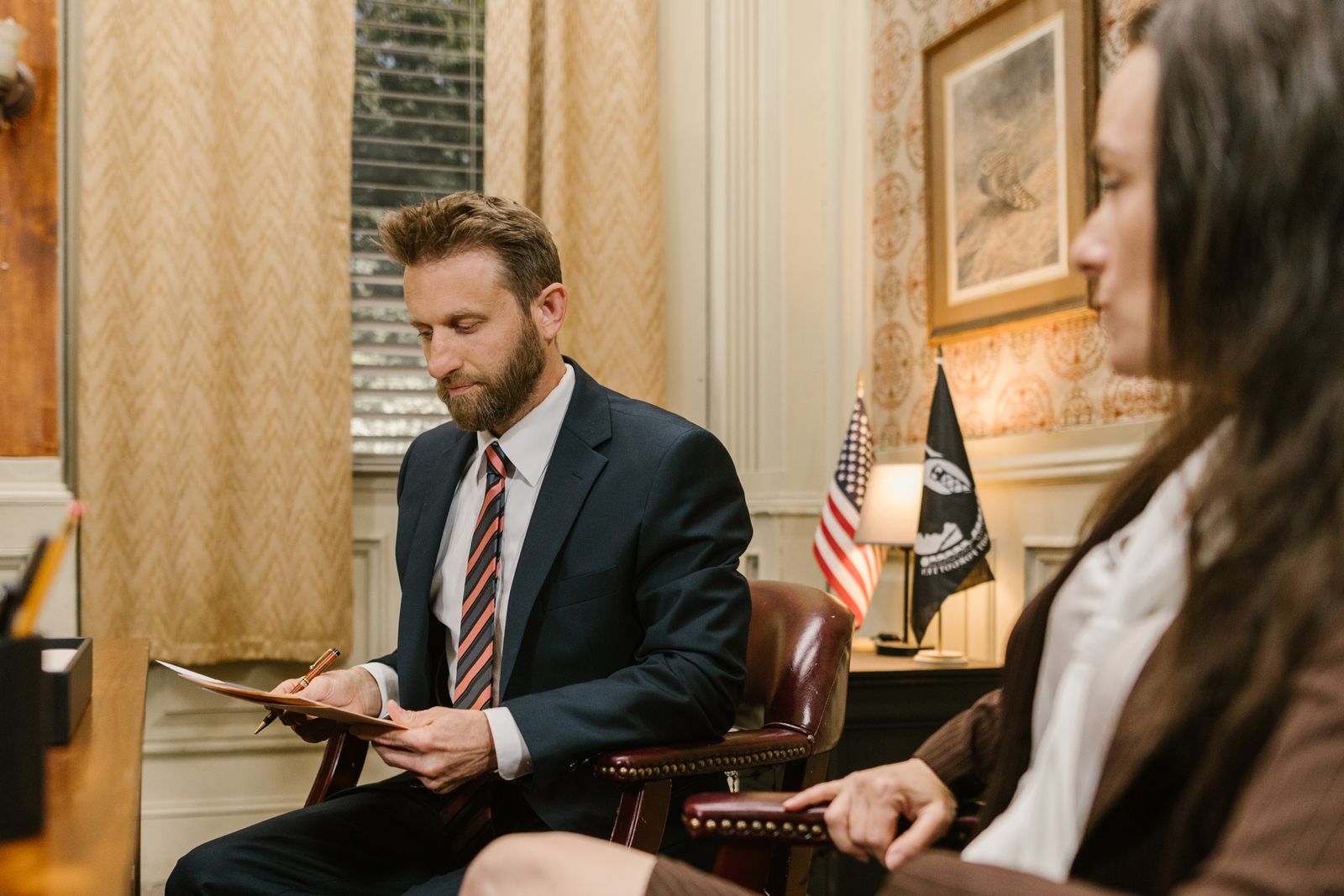 An attorney reviewing paperwork with a client across the desk